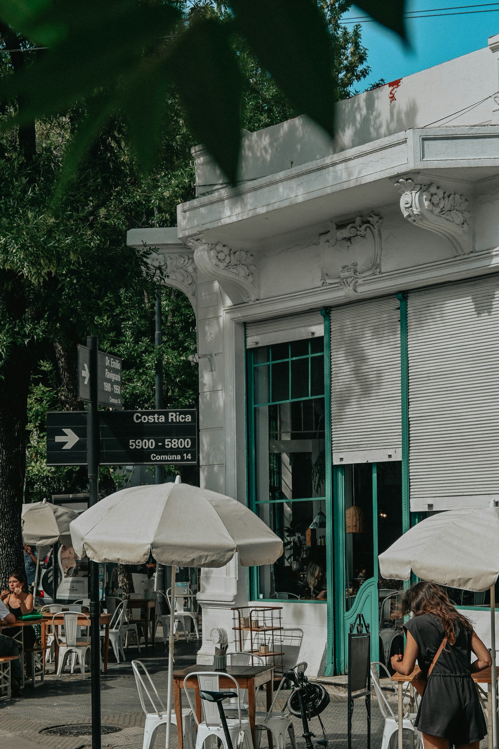 Friends gathered at a leafy Palermo cafe terrace