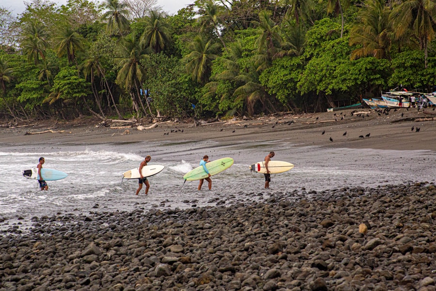 Friends carrying surfboards into the warm Pacific