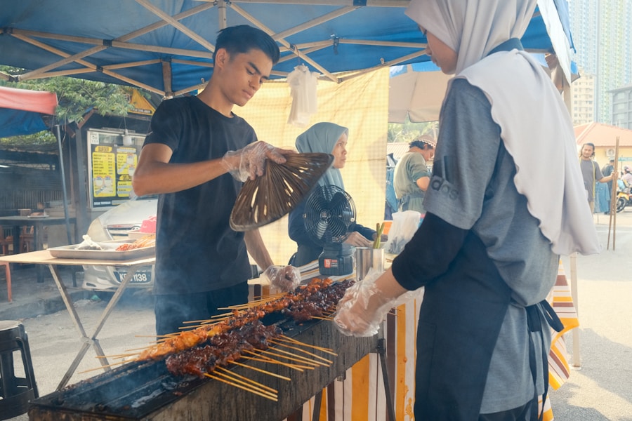 Malaysian satay grilling at a smoky outdoor street stall
