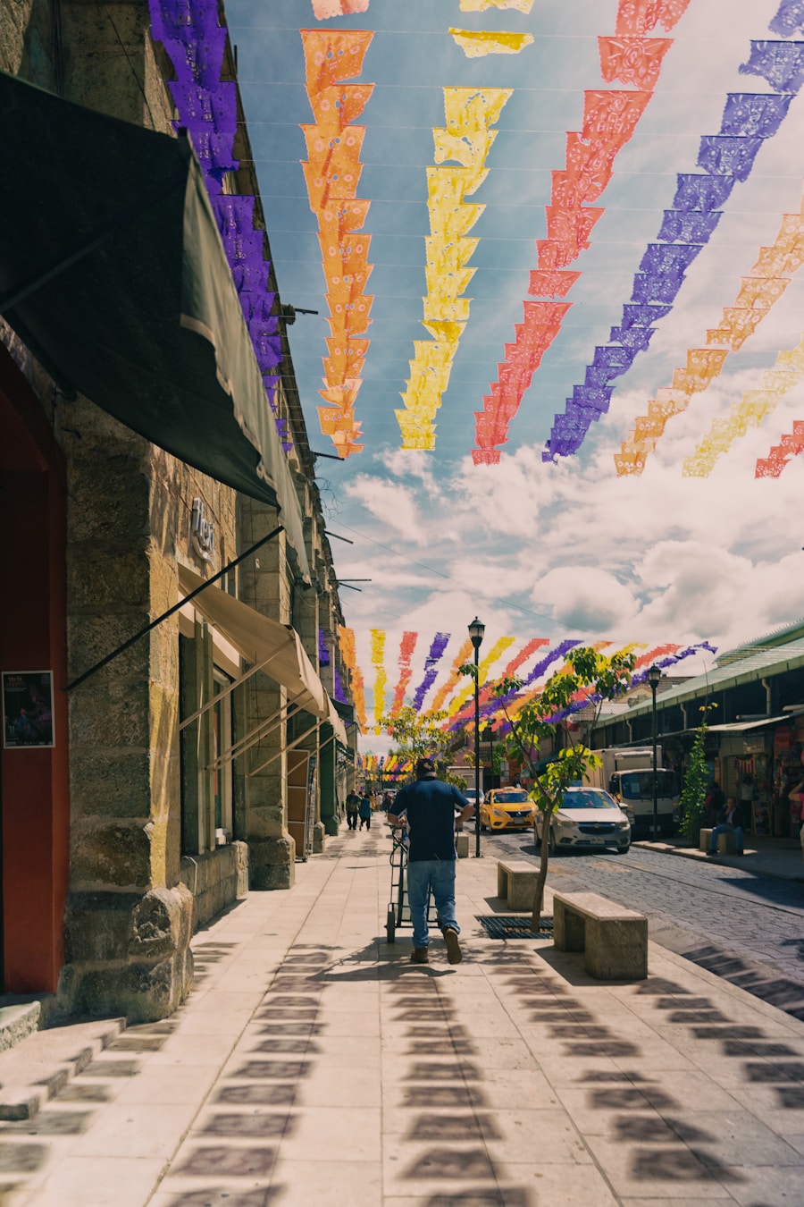 Sunlit Oaxaca street draped in colorful banners