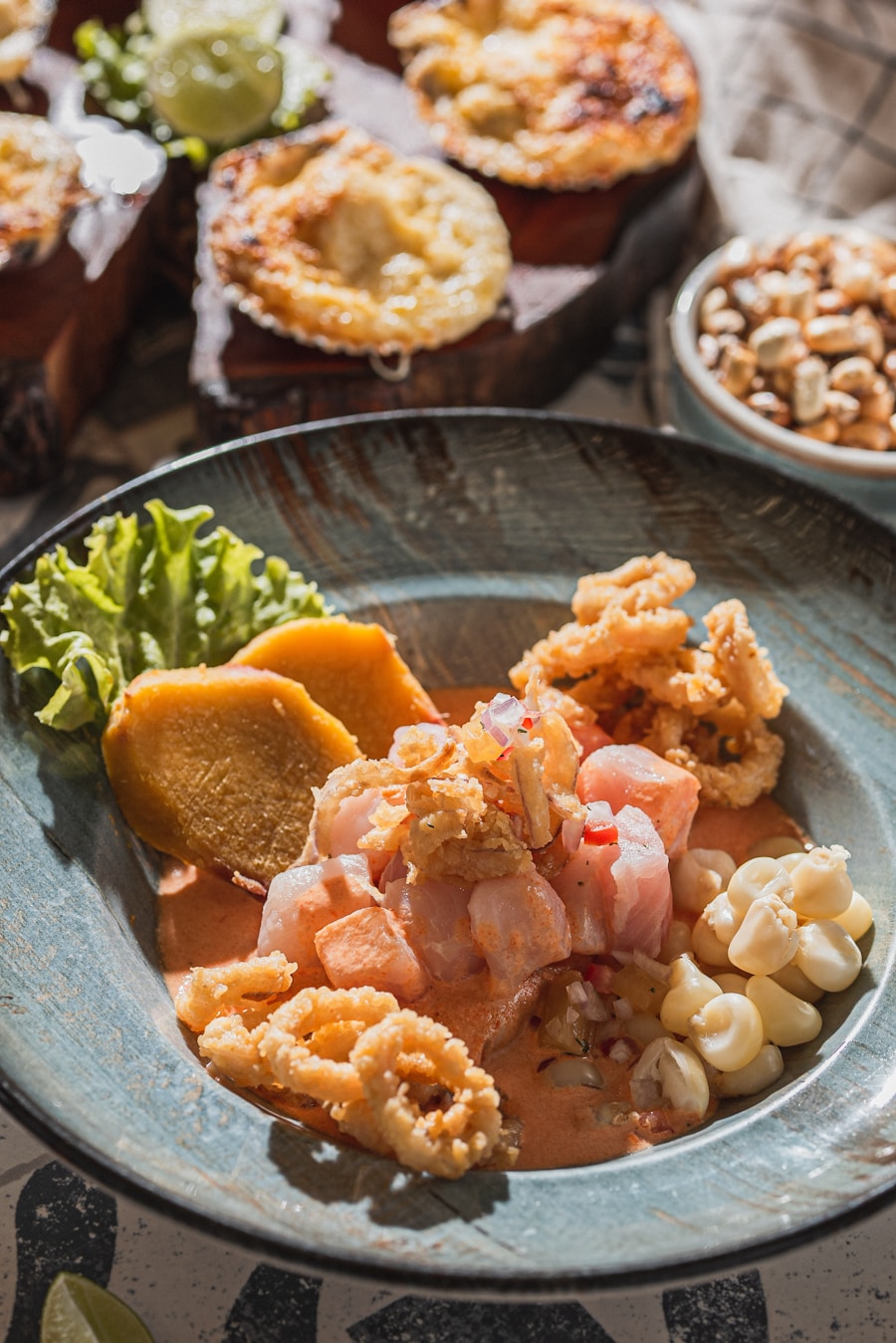 Plate of fresh Peruvian ceviche with corn and calamari