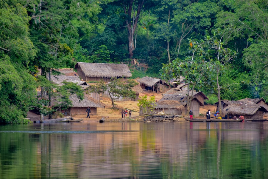 Riverside village surrounded by lush green forest