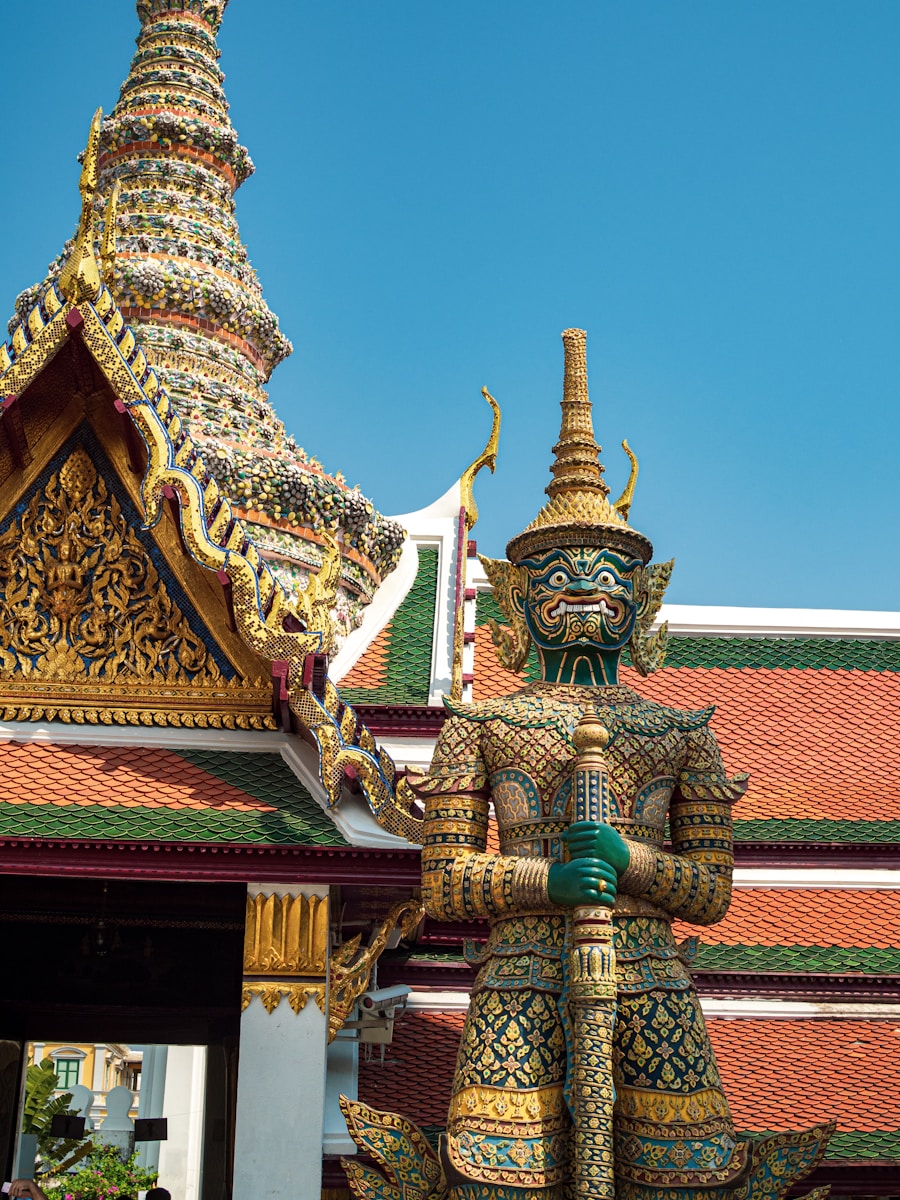 Gold and green Thai temple under a clear blue sky