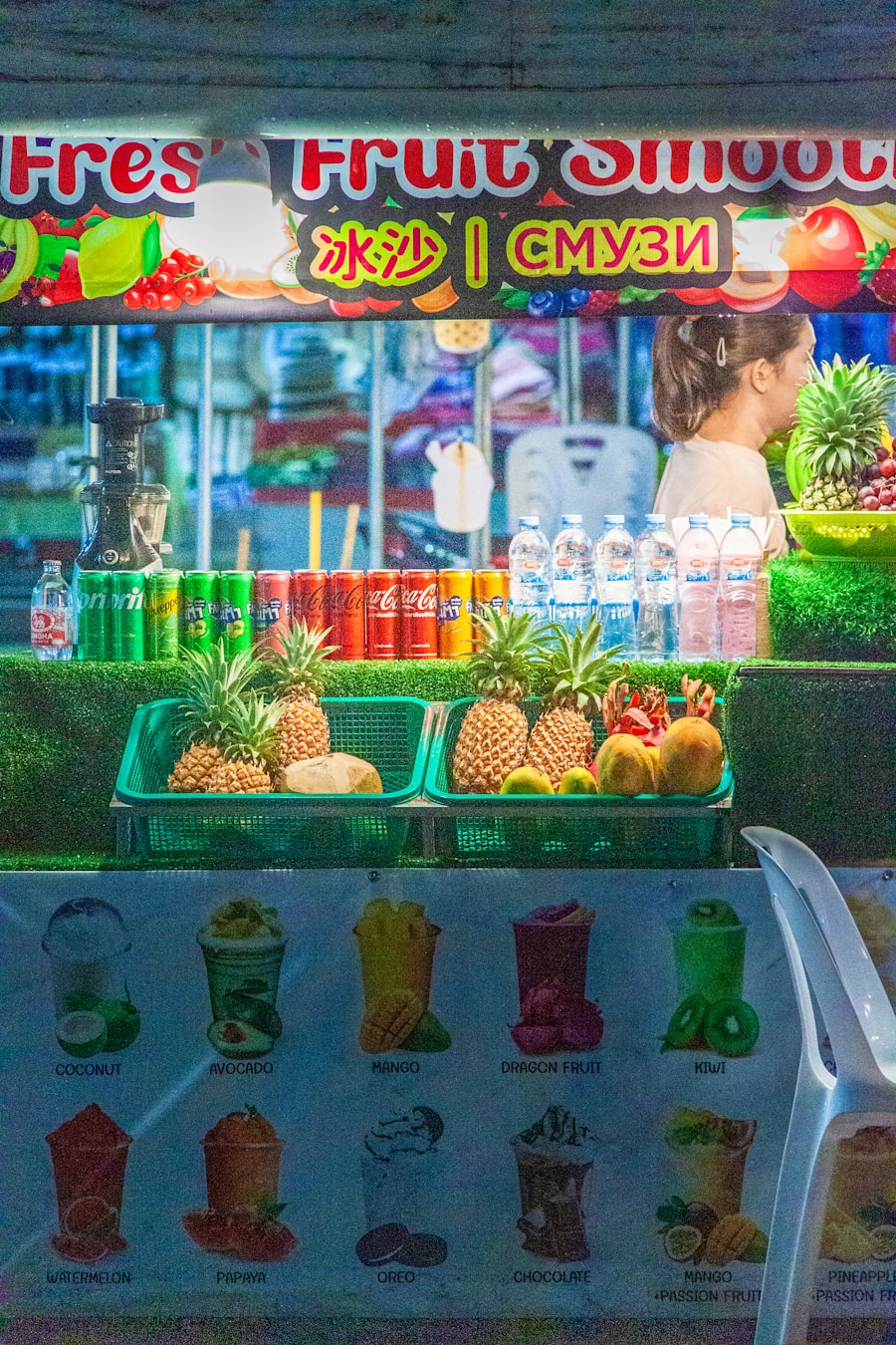Colorful Thai fruit smoothie stand at a sunny market