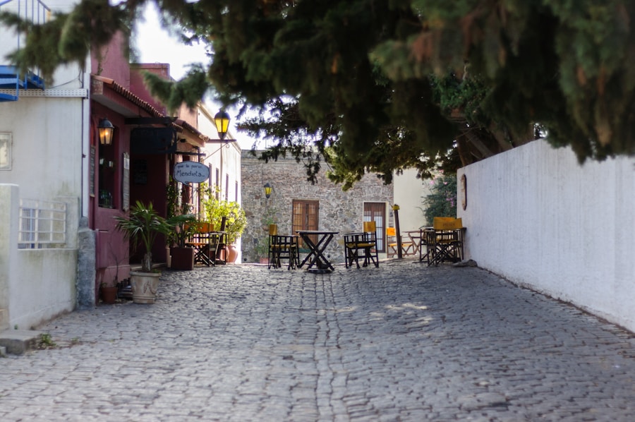 Cobblestone Colonia street lined with cafe tables