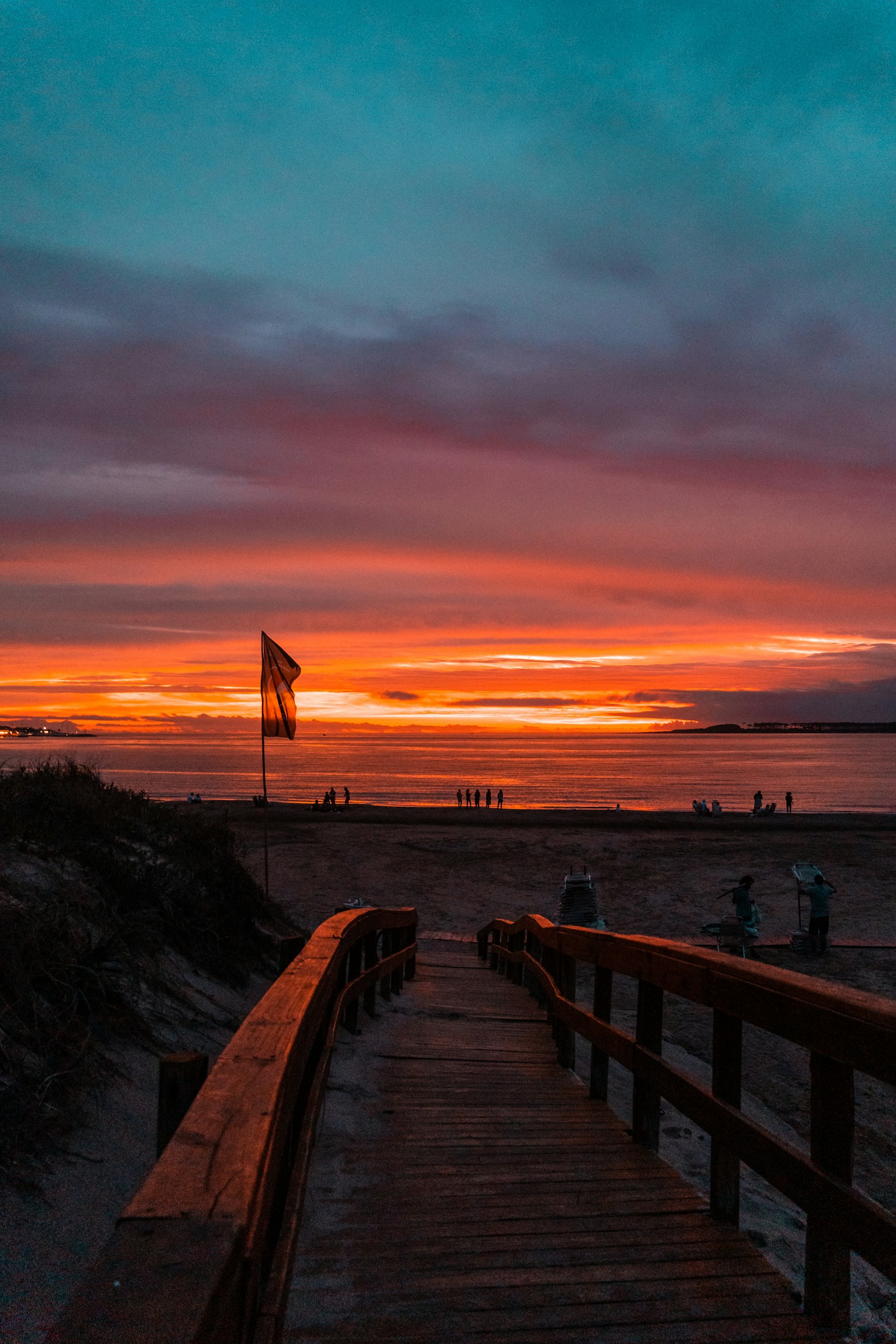 Wooden boardwalk to the Punta del Este beach at sunset