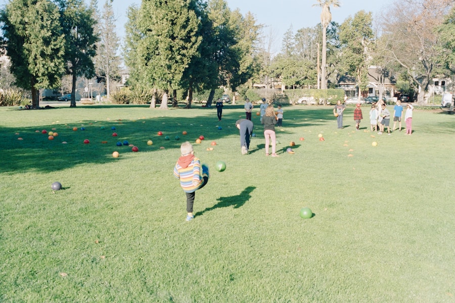 Children playing ball in a sunlit grass park